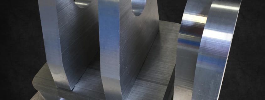 CNC Machined 32mm-thick aluminium cylinder hinges for Austal, Australia. An example of CNC Machining Aluminium by Routers Australia