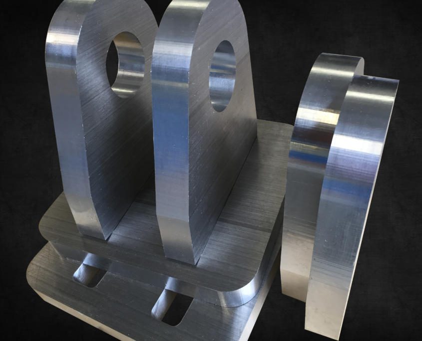 CNC Machined 32mm-thick aluminium cylinder hinges for Austal, Australia. An example of CNC Machining Aluminium by Routers Australia