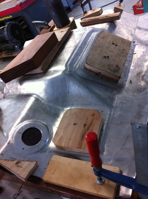 Hand forming the GT40 aluminium footwell over the wooden buck